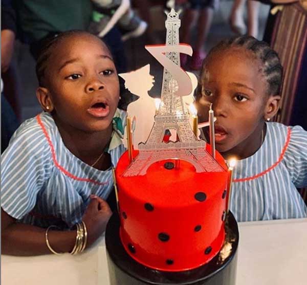 Ciccone twins taking a photo with their birthday cake